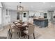 Bright open-concept dining area featuring a wood table and kitchen island with seating at 230 Shorewood Ct, Mcdonough, GA 30252