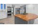 Spacious kitchen with stainless appliances, custom cabinets, and an island with a wood countertop at 230 Shorewood Ct, Mcdonough, GA 30252