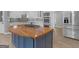 View of the kitchen featuring a central island, modern appliances, and sleek countertops at 230 Shorewood Ct, Mcdonough, GA 30252