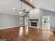 Cozy living room with a fireplace, hardwood floors, and vaulted ceilings at 230 Shorewood Ct, Mcdonough, GA 30252