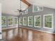 Bright living room featuring hardwood floors, multiple windows, and vaulted ceilings at 230 Shorewood Ct, Mcdonough, GA 30252