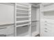 Spacious walk-in closet with custom white shelving and drawers for optimal organization at 230 Shorewood Ct, Mcdonough, GA 30252