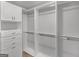 Bright walk-in closet featuring built-in cabinets, drawers and custom shelving system at 230 Shorewood Ct, Mcdonough, GA 30252