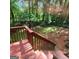 An eye-level view of the wooded backyard and deck at 190 Princeton Way, Covington, GA 30016