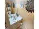 Bathroom with white vanity, mirror, decor, and a sunburst decoration at 190 Princeton Way, Covington, GA 30016