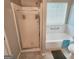 Bathroom featuring tiled floors and a shower-tub combo with sliding glass doors at 190 Princeton Way, Covington, GA 30016