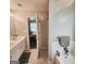 Bathroom with double vanity and combined tub and shower with an open doorway to main bedroom at 190 Princeton Way, Covington, GA 30016
