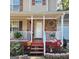 A close-up of the home's front porch, featuring stone accents, a decorative window and charming decor at 190 Princeton Way, Covington, GA 30016