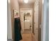 Hallway with coat rack leads to laundry room with washer and dryer at 190 Princeton Way, Covington, GA 30016