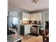 Functional kitchen with white cabinets, stainless steel appliances, and a view into the living room at 190 Princeton Way, Covington, GA 30016