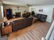 Open-concept living room with a fireplace, plush leather seating, and hardwood floors throughout at 190 Princeton Way, Covington, GA 30016