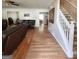 Spacious living room featuring hardwood floors, a staircase, and comfortable leather furniture at 190 Princeton Way, Covington, GA 30016