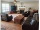 Bright living room with hardwood floors, leather furniture, and a cozy fireplace at 190 Princeton Way, Covington, GA 30016