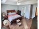 This main bedroom has wood floors, a ceiling fan, and an ensuite bathroom at 190 Princeton Way, Covington, GA 30016