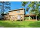Lush backyard featuring a two-story home with a deck, covered area, and green lawn at 115 Fairview Way, Stockbridge, GA 30281