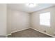 Bedroom featuring plush carpeting and a window providing natural light at 115 Fairview Way, Stockbridge, GA 30281