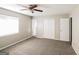 Bedroom with plush carpeting, ceiling fan, window, and closet for ample storage at 115 Fairview Way, Stockbridge, GA 30281