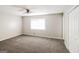 Bedroom with plush carpeting, ceiling fan, and a window providing natural light at 115 Fairview Way, Stockbridge, GA 30281