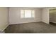 Cozy bedroom featuring plush carpet, neutral paint, a window offering ample light, and a minimalist aesthetic at 115 Fairview Way, Stockbridge, GA 30281