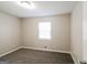 Bedroom featuring plush carpeting and a window for natural light at 115 Fairview Way, Stockbridge, GA 30281
