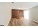 Spacious living room featuring hardwood style floors, brick wall, and sliding glass door at 115 Fairview Way, Stockbridge, GA 30281