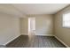 View of the spacious living room with neutral walls and a doorway to another room at 115 Fairview Way, Stockbridge, GA 30281