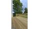 Wooden deck with scenic views of the backyard trees and landscaping at 1525 Racquet Club Dr, Lawrenceville, GA 30043