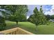 Lush backyard with expansive lawn and mature trees seen from the new wooden deck at 1525 Racquet Club Dr, Lawrenceville, GA 30043