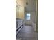 Bathroom with wood-look floors, window, and vanity at 1525 Racquet Club Dr, Lawrenceville, GA 30043