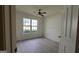 This bedroom has neutral walls, wood-look floors, ceiling fan and a window at 1525 Racquet Club Dr, Lawrenceville, GA 30043