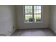 Bedroom with wood-look floors and a white-trim window providing natural light at 1525 Racquet Club Dr, Lawrenceville, GA 30043