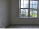 Bright room featuring white-trim window that offers backyard views at 1525 Racquet Club Dr, Lawrenceville, GA 30043