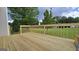 Newly constructed wooden deck extending from the house, with a view of the expansive lawn at 1525 Racquet Club Dr, Lawrenceville, GA 30043