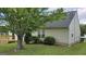 The home has a new deck, well-kept lawn, mature tree, and serene landscaping at 1525 Racquet Club Dr, Lawrenceville, GA 30043