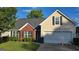 Beautiful home with manicured lawn, a two-car garage, and traditional siding at 1525 Racquet Club Dr, Lawrenceville, GA 30043