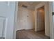 Hallway with white doors and wood-look flooring at 1525 Racquet Club Dr, Lawrenceville, GA 30043