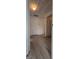 Hallway with neutral walls, white doors, and wood-look floors at 1525 Racquet Club Dr, Lawrenceville, GA 30043