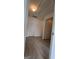 Hallway featuring neutral walls, white doors and wood-look flooring at 1525 Racquet Club Dr, Lawrenceville, GA 30043