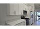 Updated kitchen featuring white cabinets, stainless steel appliances and white countertops at 1525 Racquet Club Dr, Lawrenceville, GA 30043