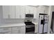 Kitchen showcasing stainless steel appliances and white cabinets and countertops at 1525 Racquet Club Dr, Lawrenceville, GA 30043