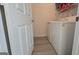 Functional laundry area equipped with a washer, dryer, and convenient shelving at 1525 Racquet Club Dr, Lawrenceville, GA 30043