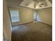 Spacious carpeted bedroom with a tray ceiling and natural light from two windows at 4551 Mitchells Meadow Ln, Ellenwood, GA 30294