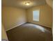 Bedroom with neutral walls and carpet; window with blinds at 4551 Mitchells Meadow Ln, Ellenwood, GA 30294