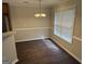 Dining area featuring wood floors, a window, and chandelier at 4551 Mitchells Meadow Ln, Ellenwood, GA 30294