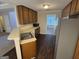 Kitchen with stainless appliances, wood cabinets, and open view into dining at 4551 Mitchells Meadow Ln, Ellenwood, GA 30294
