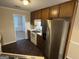 Kitchen featuring appliances, laminate countertops, and hardwood floor at 4551 Mitchells Meadow Ln, Ellenwood, GA 30294