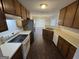 Well-lit kitchen with dark wood floors, matching cabinets, and stainless steel refrigerator at 4551 Mitchells Meadow Ln, Ellenwood, GA 30294