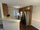 Functional kitchen with stainless steel appliances, wood cabinets and vinyl floor at 4551 Mitchells Meadow Ln, Ellenwood, GA 30294