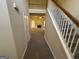 Spacious living room with a fireplace, staircase, and carpet flooring at 4551 Mitchells Meadow Ln, Ellenwood, GA 30294