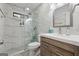 Modern bathroom with marble-style tiles, a glass shower, a wooden vanity, and updated fixtures at 2622 Murdock, Marietta, GA 30062